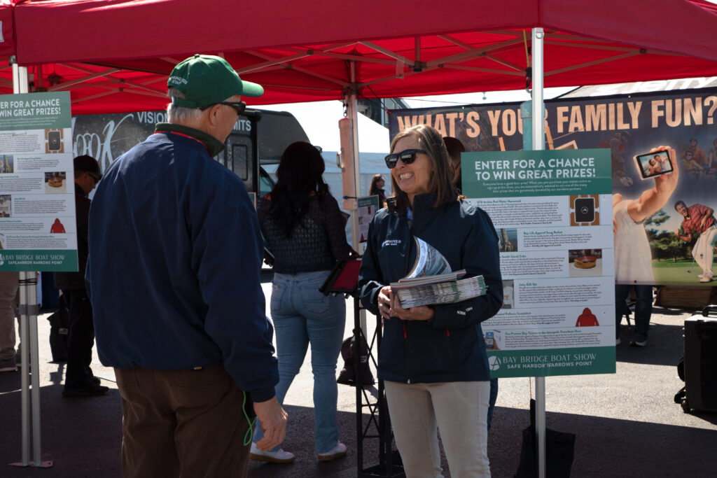Mary Ewenson (Annapolis Boat Shows President) hands out show guides - Athena Arnold Photography