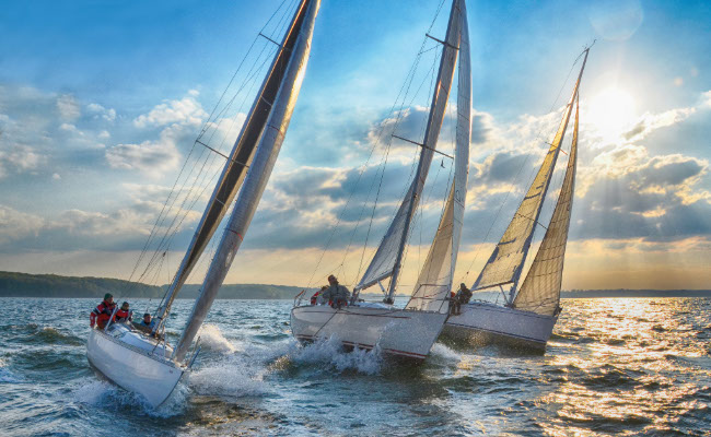 Three Sailboats on the Water