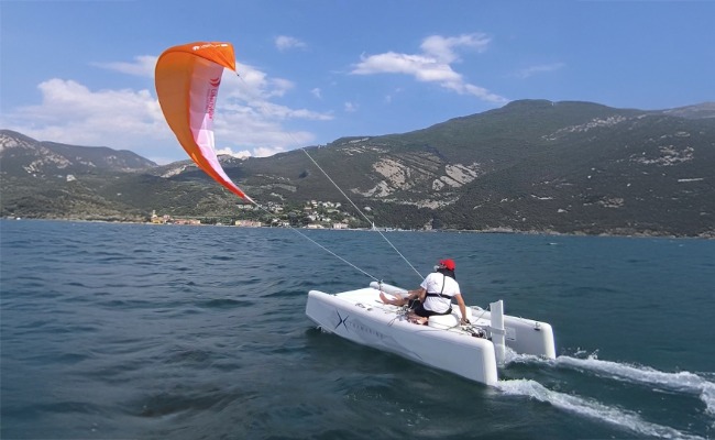 Extramarine kite boat in front of mountain range| Credit: Extramarine